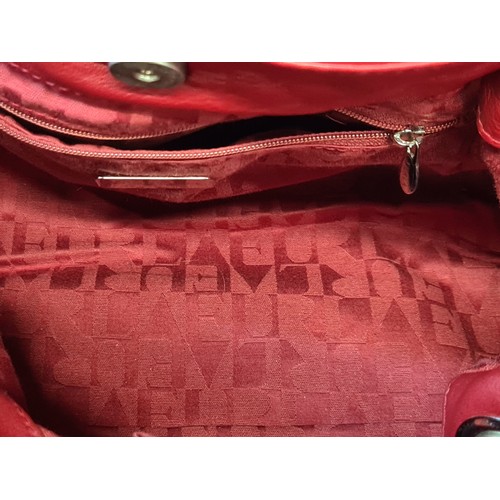 78 - A striking genuine leather ladies handbag by designer brand Furla. An elegant example in a ruby red ... 