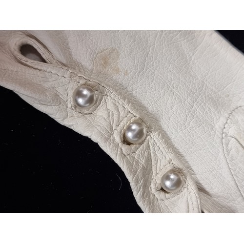 73 - Two lovely pairs of elbow length vintage women's gloves including a beautiful genuine leather white ... 