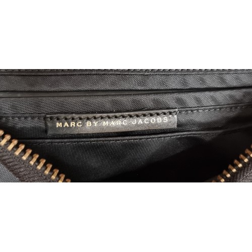 95 - A brand new and very stylish crossbody bag by designer Marc Jacobs. Designed with a thick nylon fabr... 