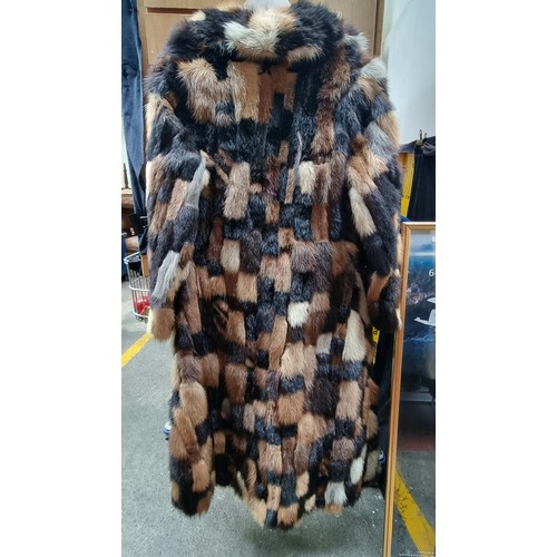 132 - Star Lot : A very elegant women's genuine fur coat. Features a patchwork of furs in tones of camel, ... 