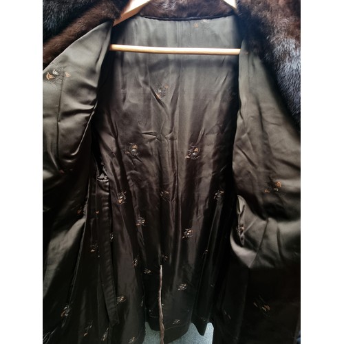 206 - A long and luscious full length genuine mink fur coat with ornate detailed buttons in good condition... 