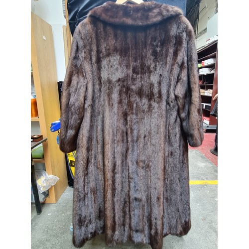 206 - A long and luscious full length genuine mink fur coat with ornate detailed buttons in good condition... 