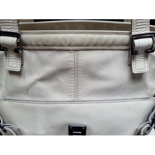 214 - A large Mulberry handbag in a soft cream patent fabric with chrome hardware and zip opening. Some we... 