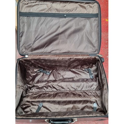 216 - A suite of three black soft leather suitcases and travel bags by Mont Blanc. Includes a large (47 x ... 