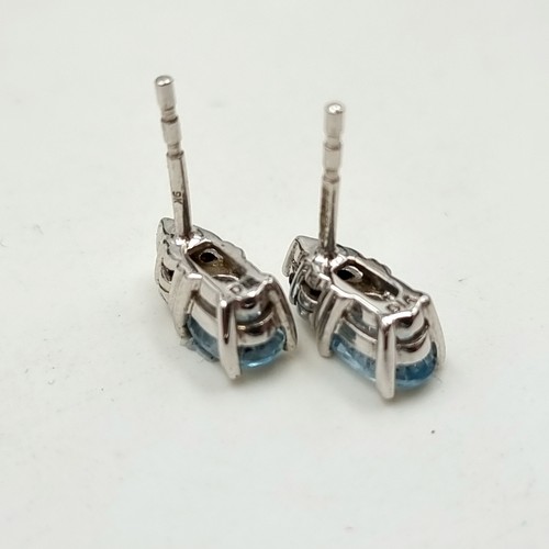 238 - Star Lot: A beautiful pair of 9 carat White Gold Diamond and Aquamarine stud earrings. These example... 