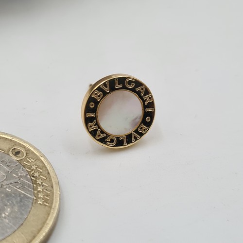 127 - A fabulous Bvlgari 18 carat gold single earing with a mother of pearl center. Sold as singles on the... 