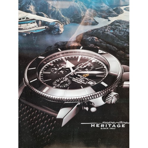 230 - A large print of an advertisement for for Breitling watches showing the superocean heritage collecti... 