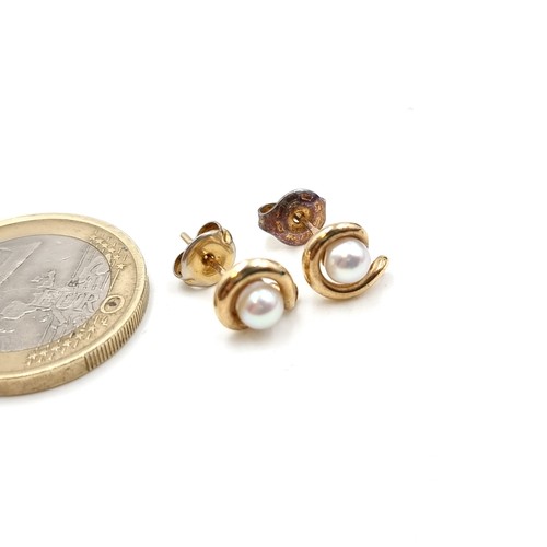 704 - A pair of 9 carat Gold Pearl stud earrings. Presented in a gift box.