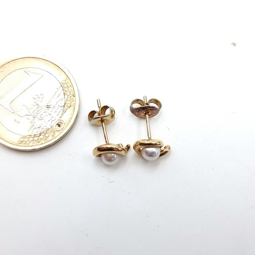 704 - A pair of 9 carat Gold Pearl stud earrings. Presented in a gift box.