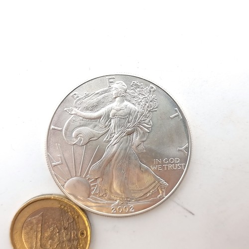 854 - An American Silver Eagle 1 ounce fine silver One Dollar bullion coin. The obverse reads the year the... 