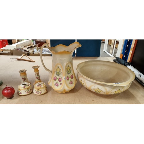 835 - Six porcelain items including a large basin and pitcher, two candle sticks and two lidded jars all w... 