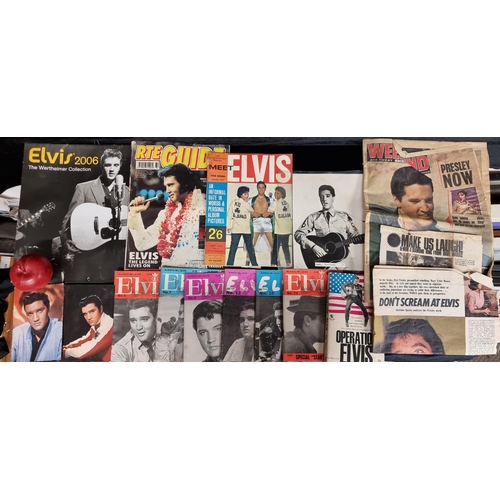 256 - A collection of fourteen Elvis items including postcards, magazines and a calendar.