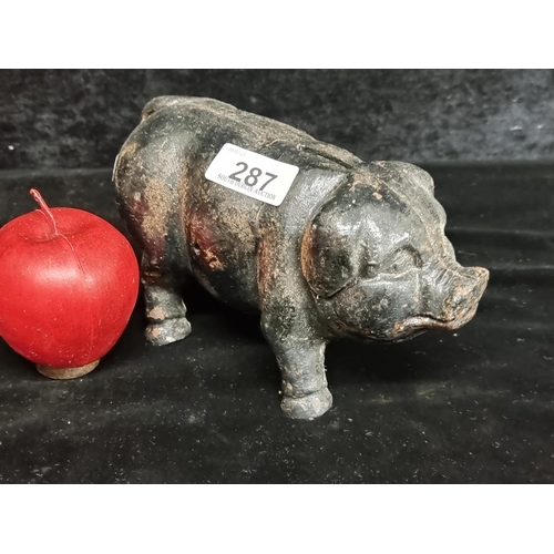 287 - A very heavy cast metal piggy bank in a black finish.