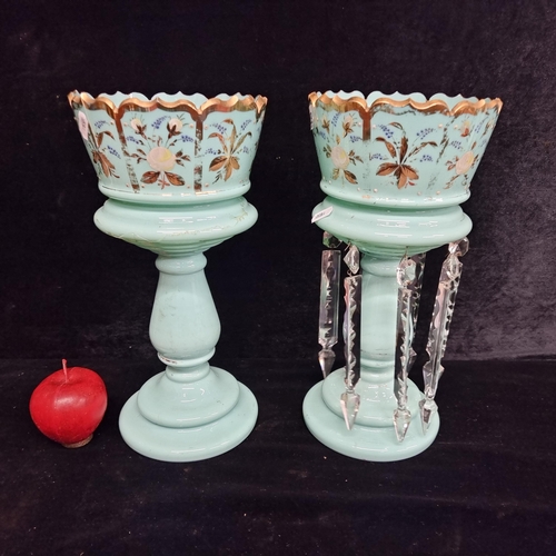 289 - A pair of very ornate porcelain lusters  on high pedestal base in a mint blue with a gilt floral mot... 