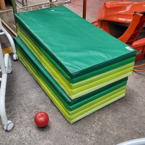 A pair of folding gym mats in the Plufsig series in graduated shades of green. 185cm X 78cm. RRP €45