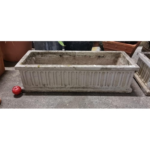 748 - A large rectangular trough planter. A very heavy example in reconstituted stone. With recessed geome... 