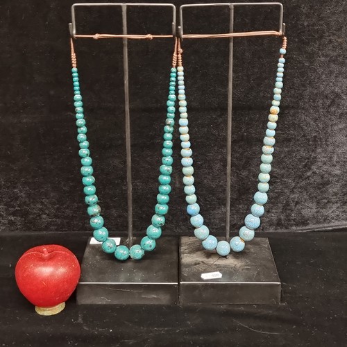 295 - A pair of necklace stands containing two ceramic beaded necklaces with beautiful mottled blue and gr... 