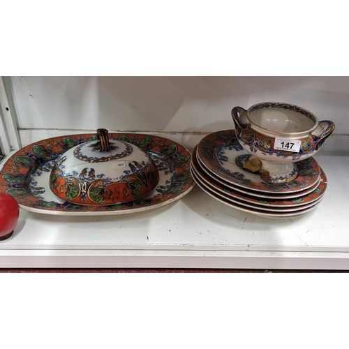 147 - A collection of nine matching antique serving ware pieces including five dinner plates, a smaller an... 