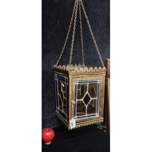 200 - Star lot : A stunning antique hanging hall lantern. With four stained glass panels in rich shades of... 