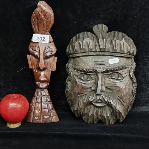 202 - Two vintage wooden hand carved items. Both depicting male faces including an African warrior example... 