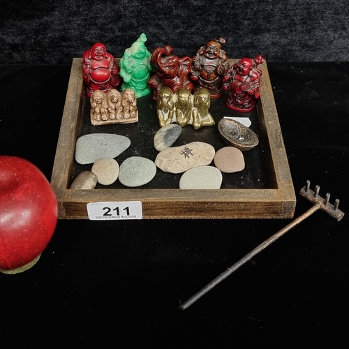 211 - A box containing sixteen interesting ornamental items including four Buddha figurines in red and gre... 