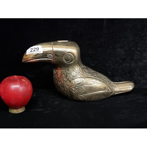 229 - A large heavy brass door stop in the form of a cute toucan with nice etched detail to feather.