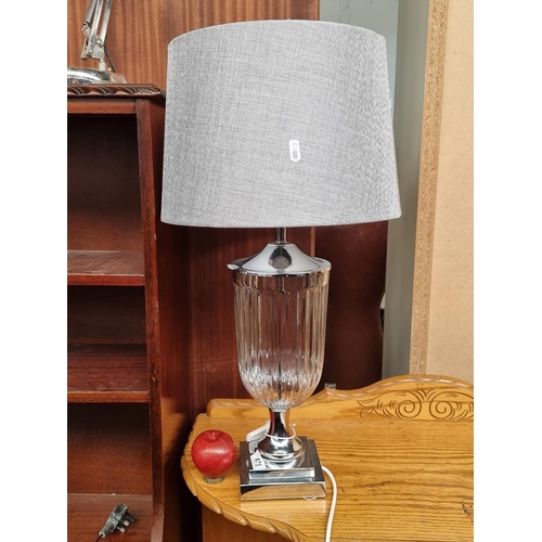 475 - A very stylish large table lamp with an urn shaped fluted glass body and steeped chrome pedestal bas... 