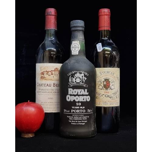 568 - Three sealed bottles of vintage red wine and port. Including a 1990 Chateau Belair which is achievin... 