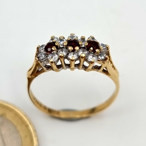 644 - A very pretty 9 carat gold stamped 375 garnet and gemstone daisy set ring. Size N. Weight: 1.92 gram... 