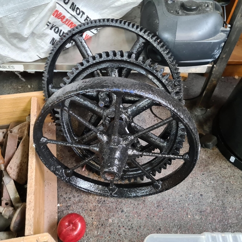 851 - Three vintage cast iron wheels including an agricultural example (D38cm) and two machinery wheels (D... 