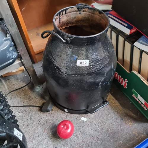 852 - A lovely antique milk churn with a swing handle. In a glossy black finish.