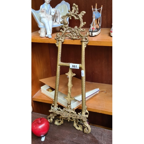 861 - A fabulous and highly decorative large table top brass picture easel with elaborate scroll and folia... 