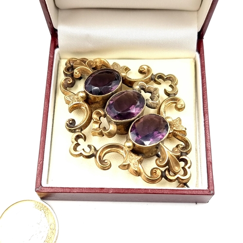 884 - A lovely antique Victorian three stone amethyst brooch with attractive filigree and foliate detailin... 