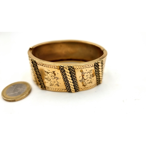 888 - A fine quality vintage gold plated bangle bracelet with attractive raised detailing. 
MM: W6.5 cm
We... 