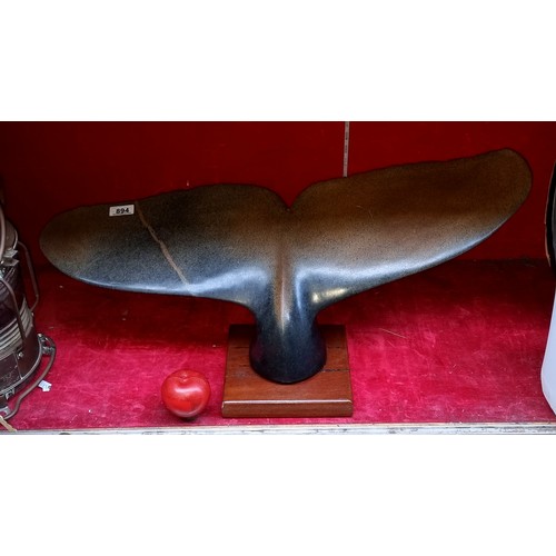 894 - Star Lot : A very large and heavy slate  Shona sculpture of a whale tail mounted on a wooden base, s... 