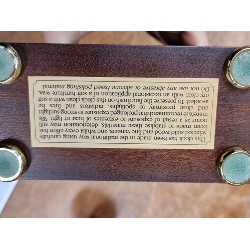 197 - A lovely Knight & Gibbins mantel clock. Of wonderful hourglass form with a solid wood case, convex g... 