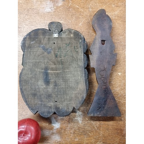 202 - Two vintage wooden hand carved items. Both depicting male faces including an African warrior example... 