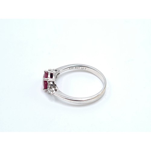 44 - Star Lot: An attractive 18 carat white gold ruby and diamond ring stamped 750 to band. Ruby fitted w... 