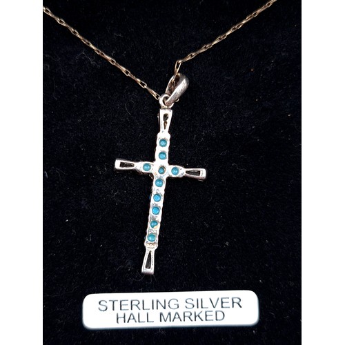 649 - A sterling silver pendant cross necklace with turquoise and gemstone setting, in original presentati... 