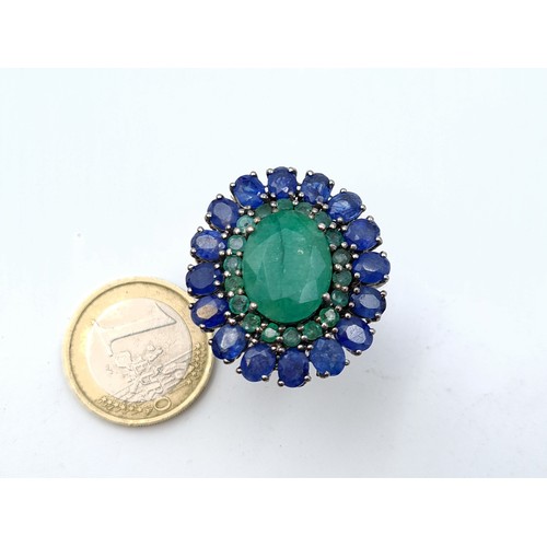 653 - Star Lot : A  new fabulous large emerald stone set ring with emerald and sapphire surround mounted i... 