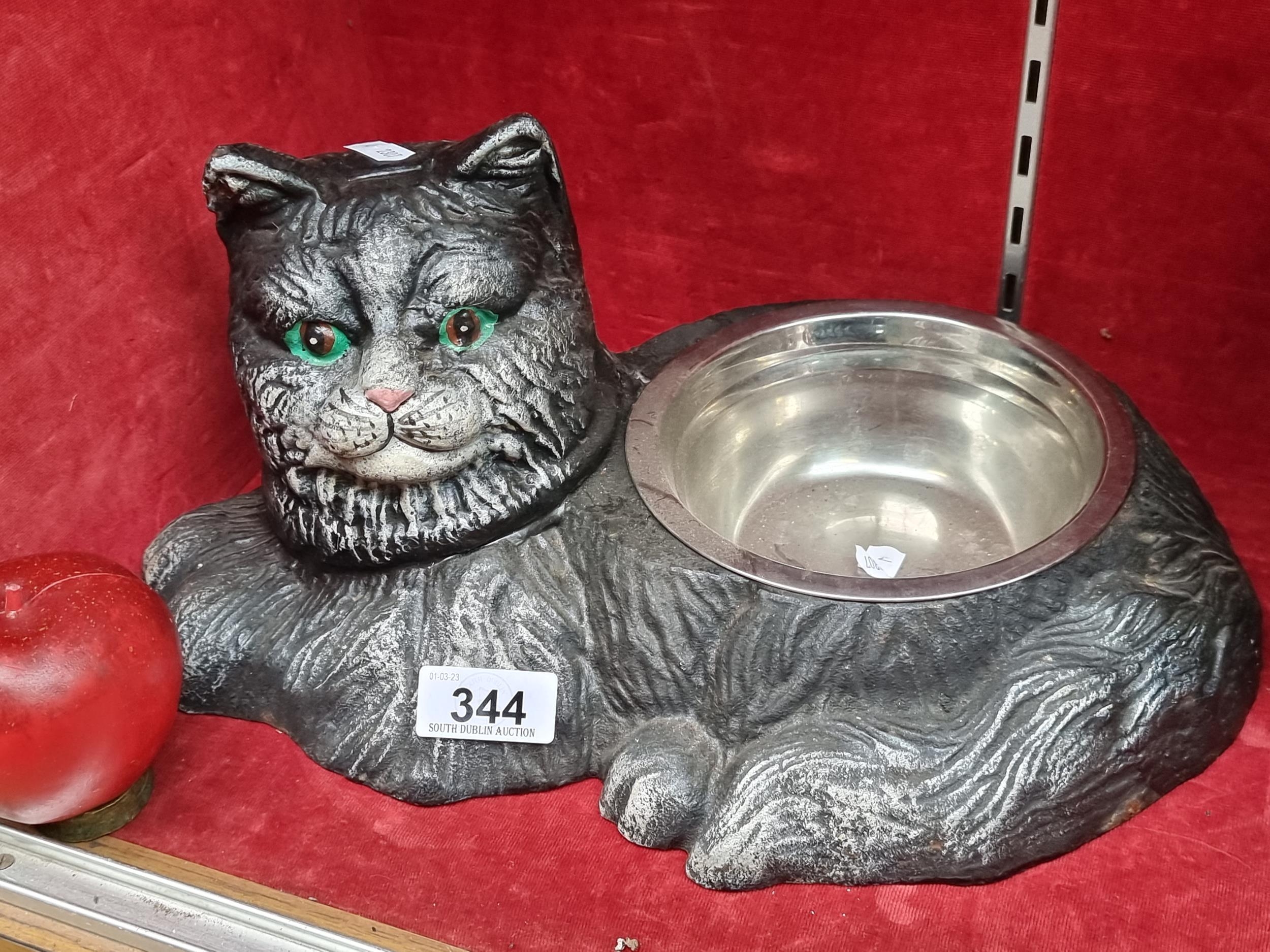 A charming very heavy cat bowl in the form of a curled up black cat. With removable steel dish. Indo