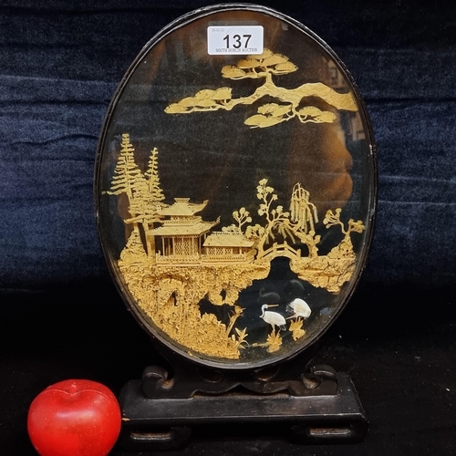 137 - A Victorian Chinoiserie style framed diorama. Crafted from carved cork and depicting a detailed pago... 