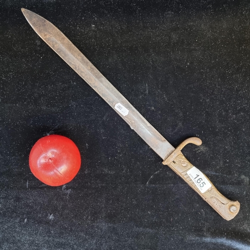 165 - A 1916 patterned German Mauser bayonet knife with hooked quillion. Featuring a carved wooden hilt an... 