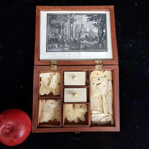 242 - A beautiful mid 19th century  games box filled with many bone tokens embossed with petite motifs of ... 