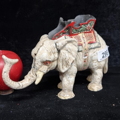 298 - A charming cast metal money bank in the form of a circus elephant. With articulated trunk and tail.