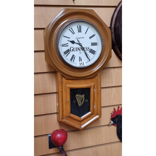 312 - An Ansonia Guinness branded wall clock with octagonal frame and Roman Numeral dial.