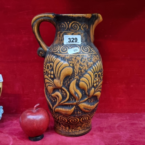 329 - A ceramic 1960s West German jug vase marked to base '671 30 Bay'. With a large floral and spiral des... 