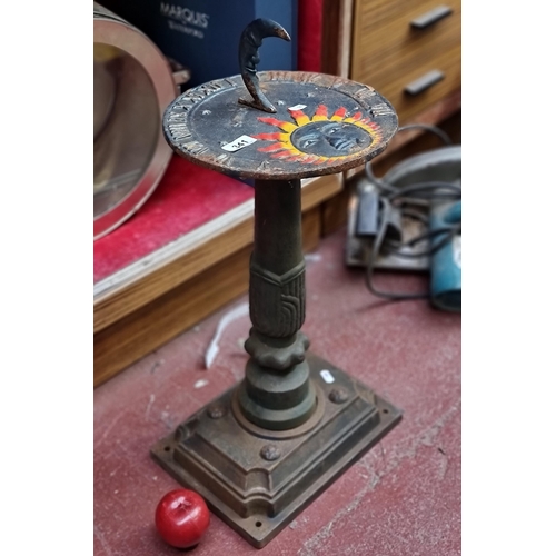 341 - A fabulous very heavy cast metal sun dial with a sun and moon design and Roman numerals. In a metall... 