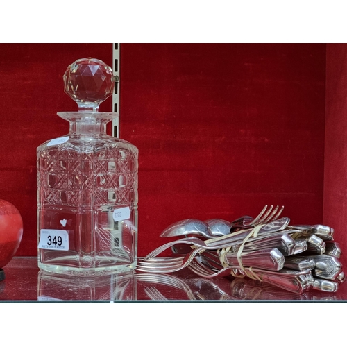 349 - A cut glass decanter with a faucet stopper. Along with 24 pieces of sliver plated cutlery.