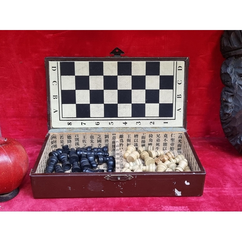 357 - A handsome box containing a travel chess set with fold out board and full 32 pieces.